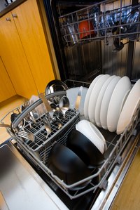Cleaning away dried soap scum is part of maintaining a dishwasher.