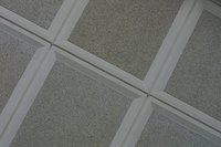 Suspended ceilings hang below joists and leave a gap at stairways.