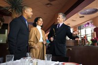 Restaurant host showing a couple to their table.