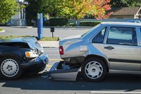 Car accident with a rear bumper on the ground.