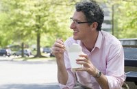 Image of an employee eating lunch outdoors.