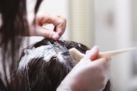 A woman getting her hair dyed at a salon.