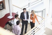 Co-workers discussing work in an office.