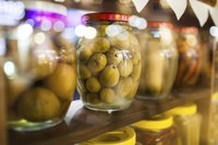 Pickled foods in jars on a shelf.