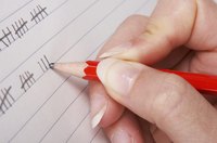 Close-up of woman marking tallies on piece of paper.