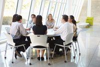 Business professionals have a meeting at a table.