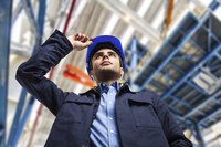 A view looking up at an engineer in a plant.
