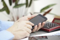 Man using calculator on cell phone