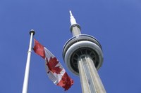 CN Tower next to Canadian flag