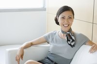 Smiling young business professional on couch.