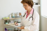 A doctor writing on a clipboard in an exam room.