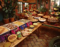 Jazz up your buffet table by adding colorful decorations and multiple layers of food.
