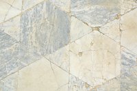 Floor tile damage can be caused by dips in the subfloor.