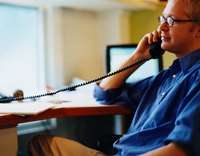 Internal Revenue Agent making phonetical from desk.