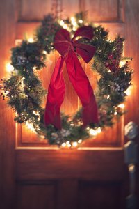 Attach the bow to the wreath with a dab of hot glue or a piece of wire.