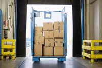 A warehouse with inventory on a cart.
