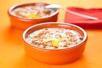 Two bowls of arroz con leche on table top.