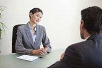 Business woman talking to an employee in an office.