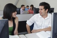 Student speaking with other student in computer lab