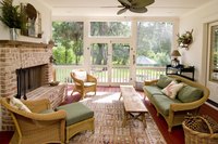 A balance of complementary hues merges the sunroom with its surroundings.