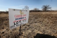 A sign advertising a vacant lot for sale.