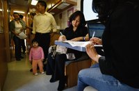 Patients filling out forms in a medical office.