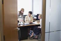 Three businesswomen talking in an office.