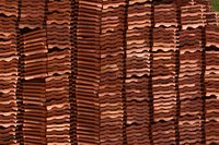 Roof tiles are designed to be hooked over wood battens that hold the tiles in place.