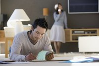 A businessman is working from his house.