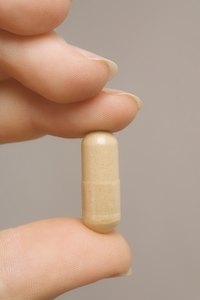 A woman is holding a fiber supplement.