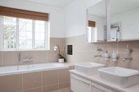 Vessel sinks sit on top of the countertop -- a modern wash basin option.