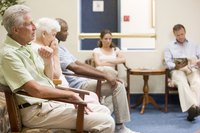 Patients wait in the reception area of a doctors office.