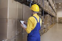 A worker taking inventory in a shipping warehouse.
