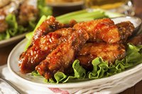 Serve hot chicken wings with cold vegetables to provide a contrast for your palate.