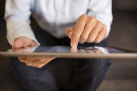 A businessman uses his tablet computer.