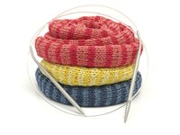 Circular knitting needles have two uses: knitting seamless tubes and knitting large projects, like afghans, in one piece.