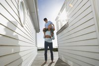 Father and son walking in-between weatherboards