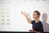 Woman speaking at large business seminar