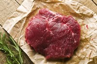 Piece of raw steak on brown paper