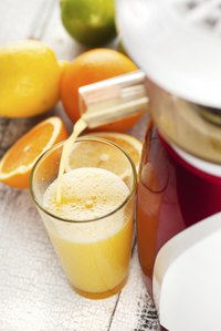Close-up of a juicer pouring out fresh orange juice.