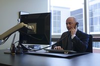 A professonial man working at a desk in an office.