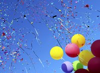 Image of birthday balloons floating away.