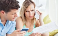 Stressed couple calculating bills