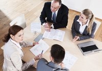Businesspeople are having a meeting in a boardroom.