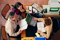 Two people are meeting with their banker.