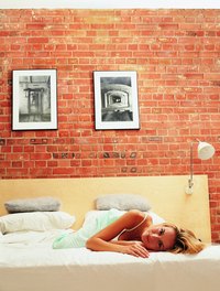 Keep pictures light to hang them on brick without drilling holes.
