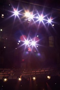Theatrical lighting designers plan and place stage lights.