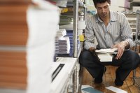A man is organizing a workspace area.