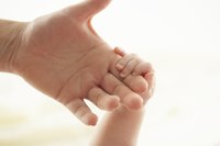 Unfurl a baby's fingers to create the strongest handprint mold.