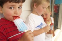 Young kids are eating colorful popsicles.
